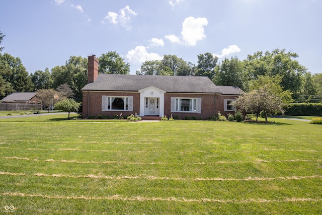 660 E Dr, Seymour, IN 47274 - view of front of home with a front yard, a chimney, brick siding, and view of wooded area