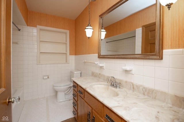 660 E Dr, Seymour, IN 47274 - full bath with vanity, tile walls, bathing tub / shower combination, wainscoting, and tile patterned flooring