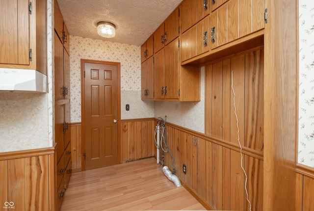 660 E Dr, Seymour, IN 47274 - washroom with wainscoting, light wood-type flooring, a textured ceiling, wallpapered walls, and wooden walls