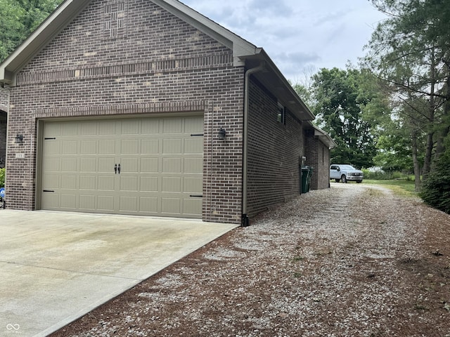 188 Gettysburg, Coatesville, IN 46121 - view of side of property featuring brick siding, driveway, and an attached garage