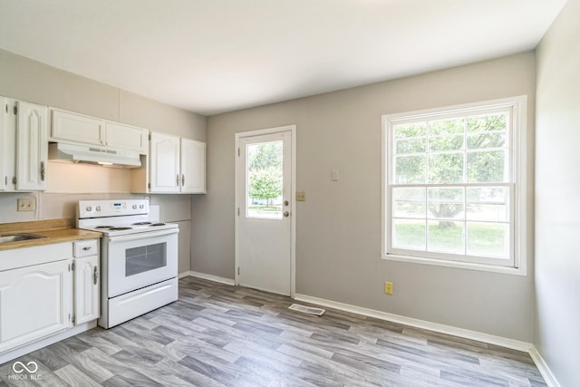 609 Willow Dr, Shelbyville, IN 46176 - kitchen with electric range, under cabinet range hood, white cabinets, light countertops, and light wood finished floors