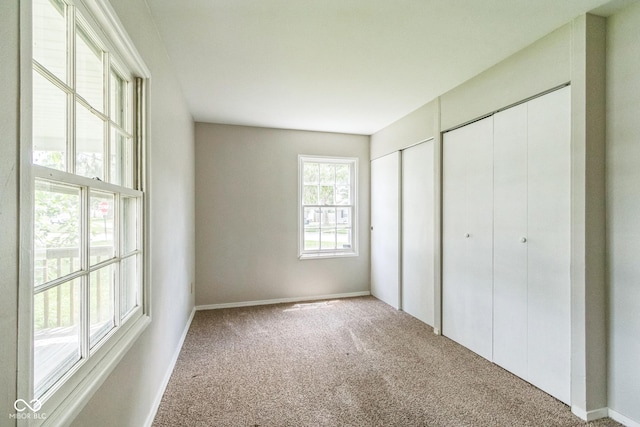 609 Willow Dr, Shelbyville, IN 46176 - unfurnished bedroom featuring multiple closets and carpet