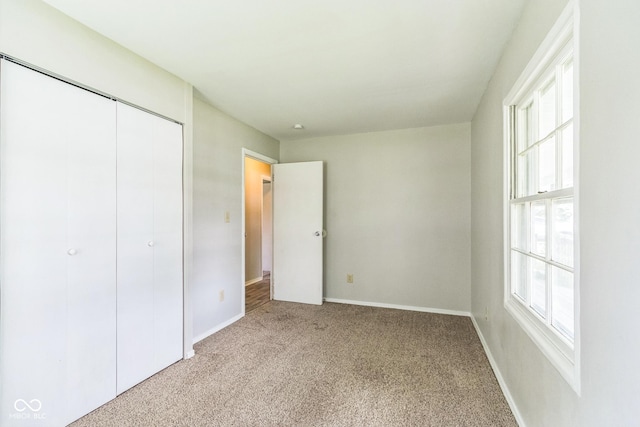 609 Willow Dr, Shelbyville, IN 46176 - unfurnished bedroom with light carpet, multiple windows, and a closet