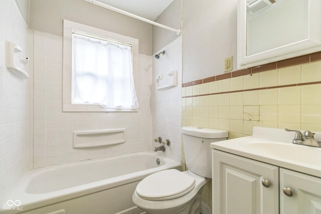 609 Willow Dr, Shelbyville, IN 46176 - bathroom featuring vanity, washtub / shower combination, and tile walls