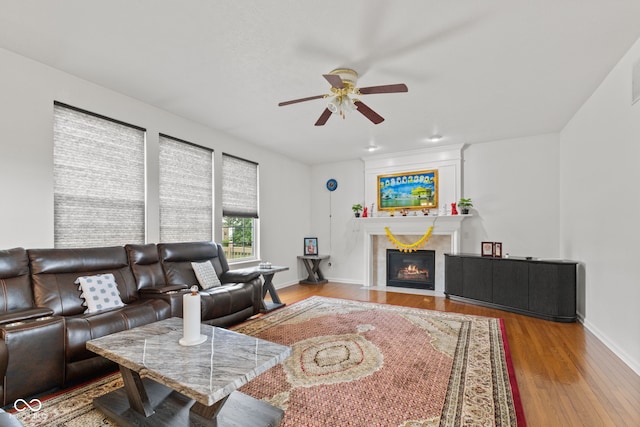 7350 Gold King Way, Indianapolis, IN 46259 - living area with a ceiling fan, wood finished floors, and a fireplace with flush hearth