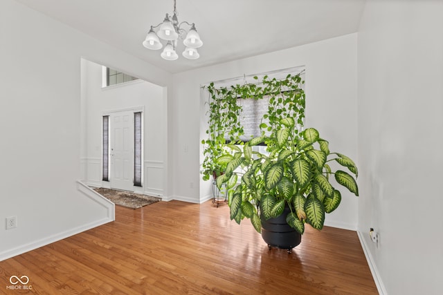 7350 Gold King Way, Indianapolis, IN 46259 - unfurnished dining area featuring a chandelier and wood finished floors