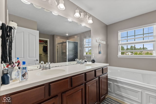 7350 Gold King Way, Indianapolis, IN 46259 - bathroom with a stall shower, double vanity, a garden tub, and a walk in closet