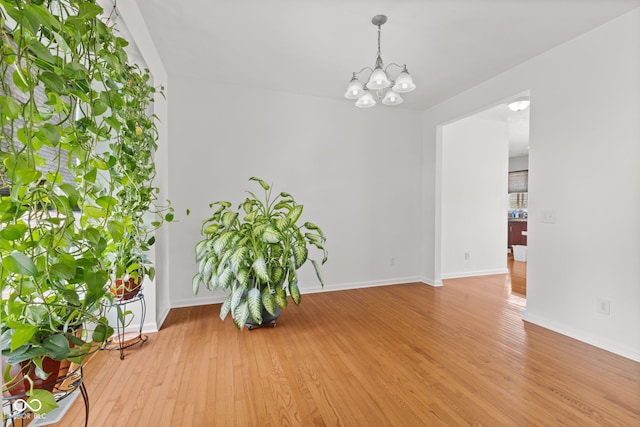 7350 Gold King Way, Indianapolis, IN 46259 - unfurnished room with a chandelier and light wood-type flooring