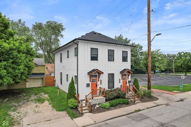 934 Calvary St, Indianapolis, IN 46203 - view of front of property with roof with shingles, driveway, and board and batten siding