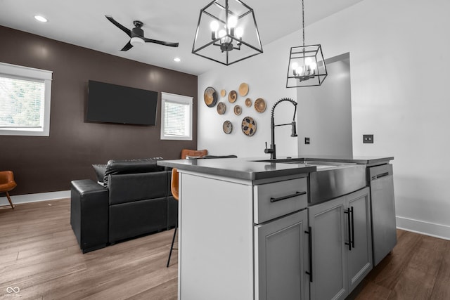 934 Calvary St, Indianapolis, IN 46203 - kitchen with stainless steel dishwasher, wood finished floors, open floor plan, an island with sink, and recessed lighting