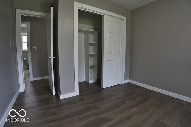 4430 Wexford Rd, Indianapolis, IN 46226 - unfurnished bedroom with dark wood finished floors and a closet