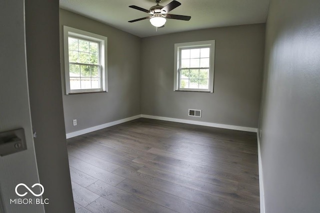 4430 Wexford Rd, Indianapolis, IN 46226 - empty room with healthy amount of natural light, dark wood-style floors, and ceiling fan
