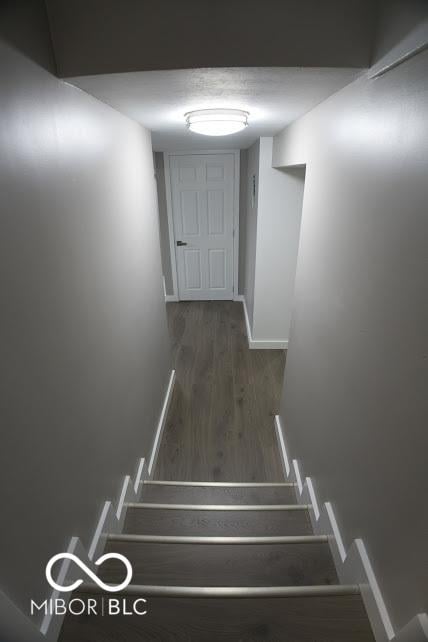4430 Wexford Rd, Indianapolis, IN 46226 - staircase featuring wood finished floors and baseboards