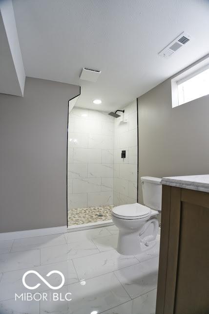 4430 Wexford Rd, Indianapolis, IN 46226 - full bathroom with tiled shower, vanity, and marble finish floors