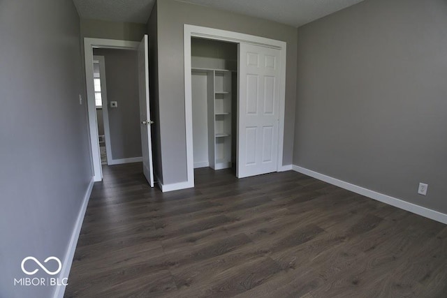 4430 Wexford Rd, Indianapolis, IN 46226 - unfurnished bedroom with dark wood finished floors and a closet