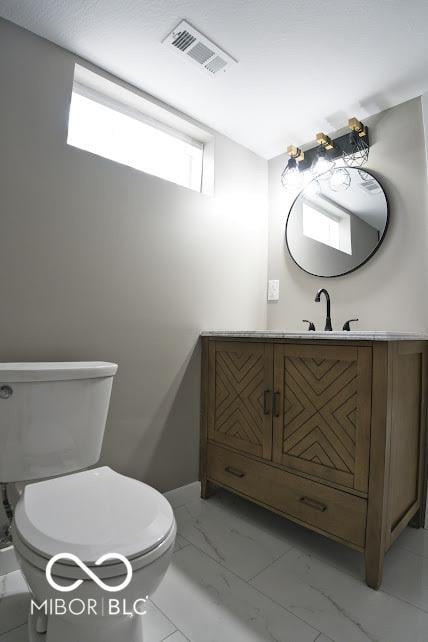 4430 Wexford Rd, Indianapolis, IN 46226 - bathroom featuring marble look tile flooring and vanity