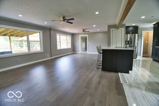 4430 Wexford Rd, Indianapolis, IN 46226 - kitchen with stainless steel fridge, open floor plan, a ceiling fan, wood finished floors, and recessed lighting