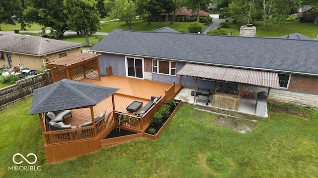4430 Wexford Rd, Indianapolis, IN 46226 - rear view of house with a deck, a yard, a shingled roof, a chimney, and a patio