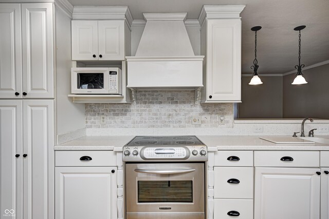303 E County Road 500 N, Pittsboro, IN 46167 - kitchen featuring custom exhaust hood, white microwave, stainless steel range with electric stovetop, ornamental molding, and light countertops