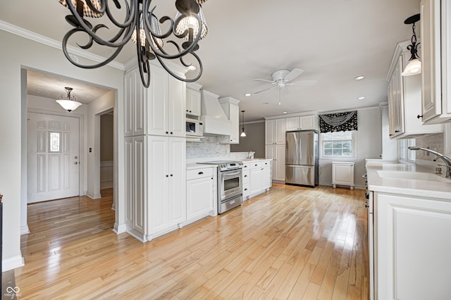 303 E County Road 500 N, Pittsboro, IN 46167 - kitchen featuring appliances with stainless steel finishes, ceiling fan, light countertops, ornamental molding, and decorative backsplash