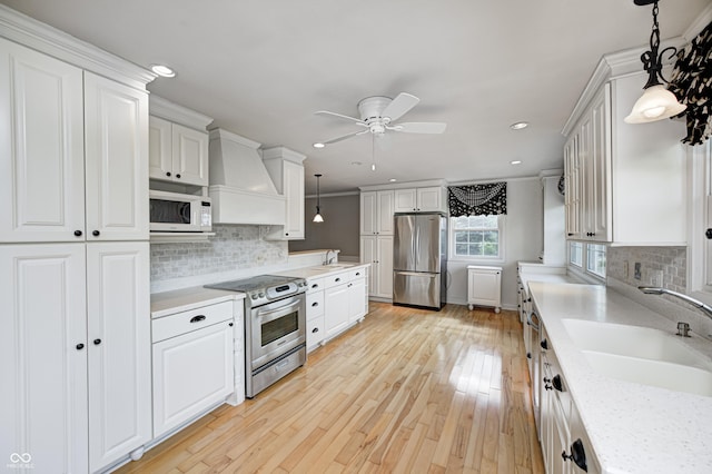 303 E County Road 500 N, Pittsboro, IN 46167 - kitchen with stainless steel appliances, premium range hood, a ceiling fan, light countertops, and recessed lighting