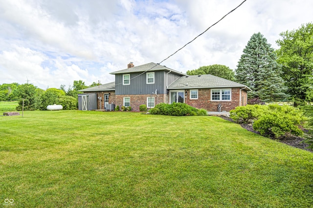 303 E County Road 500 N, Pittsboro, IN 46167 - rear view of property featuring brick siding, a yard, and a chimney