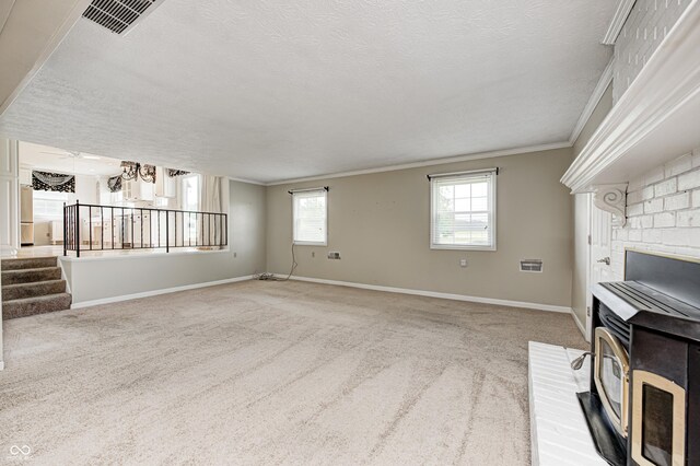 303 E County Road 500 N, Pittsboro, IN 46167 - unfurnished living room with ornamental molding, a textured ceiling, carpet, a wood stove, and stairway