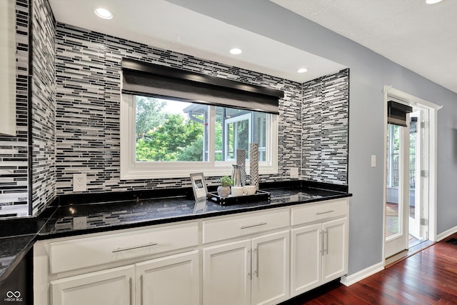 1099 Saratoga Cir, Carmel, IN 46280 - kitchen featuring backsplash, recessed lighting, dark wood-type flooring, white cabinets, and dark stone counters