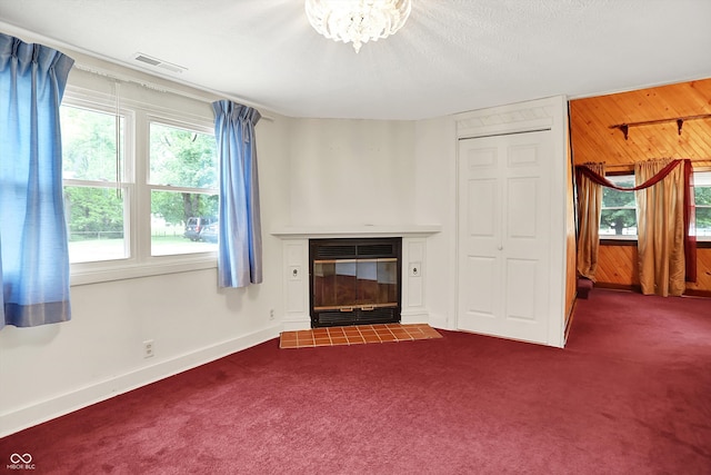 6430 E Southport Rd, Indianapolis, IN 46237 - unfurnished living room featuring dark colored carpet, wooden walls, and a tiled fireplace