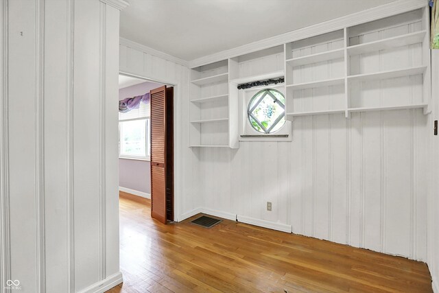 6430 E Southport Rd, Indianapolis, IN 46237 - unfurnished room featuring crown molding, hardwood / wood-style flooring, and healthy amount of natural light