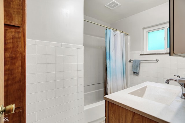 6430 E Southport Rd, Indianapolis, IN 46237 - full bathroom featuring tile walls, vanity, shower / bathtub combination with curtain, and a wainscoted wall