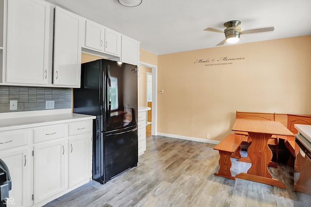 6430 E Southport Rd, Indianapolis, IN 46237 - kitchen featuring freestanding refrigerator, white cabinetry, ceiling fan, backsplash, and light countertops