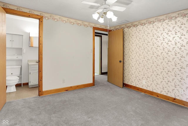 6430 E Southport Rd, Indianapolis, IN 46237 - unfurnished bedroom featuring carpet flooring, ensuite bathroom, and a ceiling fan