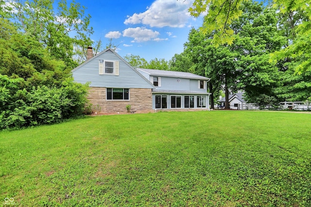 6430 E Southport Rd, Indianapolis, IN 46237 - back of house with a chimney and a yard