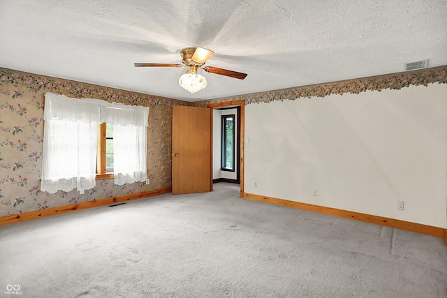 6430 E Southport Rd, Indianapolis, IN 46237 - spare room featuring plenty of natural light, light carpet, wallpapered walls, and ceiling fan
