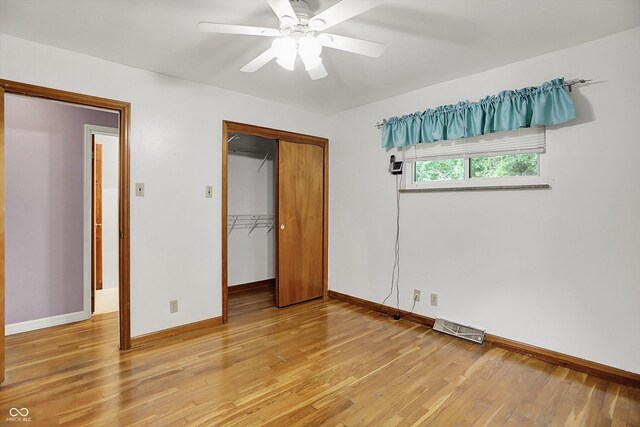 6430 E Southport Rd, Indianapolis, IN 46237 - unfurnished bedroom with light wood-type flooring, a closet, and a ceiling fan