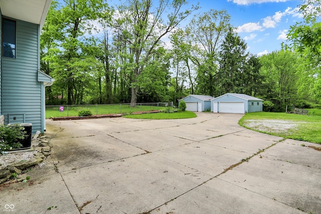 6430 E Southport Rd, Indianapolis, IN 46237 - view of patio with a garage, an outdoor structure, and view of scattered trees