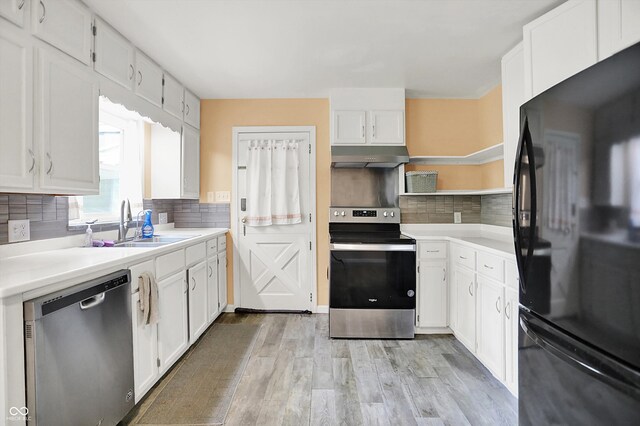 6430 E Southport Rd, Indianapolis, IN 46237 - kitchen with appliances with stainless steel finishes, under cabinet range hood, white cabinets, and light wood-style flooring