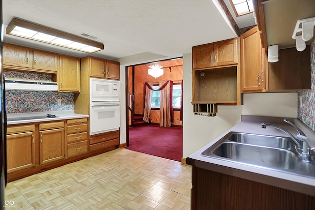 6430 E Southport Rd, Indianapolis, IN 46237 - kitchen with white microwave, brown cabinetry, light countertops, ventilation hood, and wooden walls