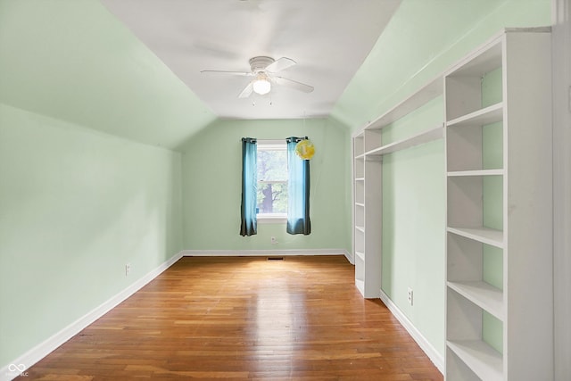6430 E Southport Rd, Indianapolis, IN 46237 - additional living space with ceiling fan, wood finished floors, vaulted ceiling, and built in features
