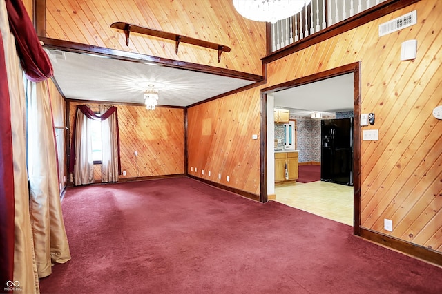 6430 E Southport Rd, Indianapolis, IN 46237 - empty room with carpet, wooden walls, and a chandelier