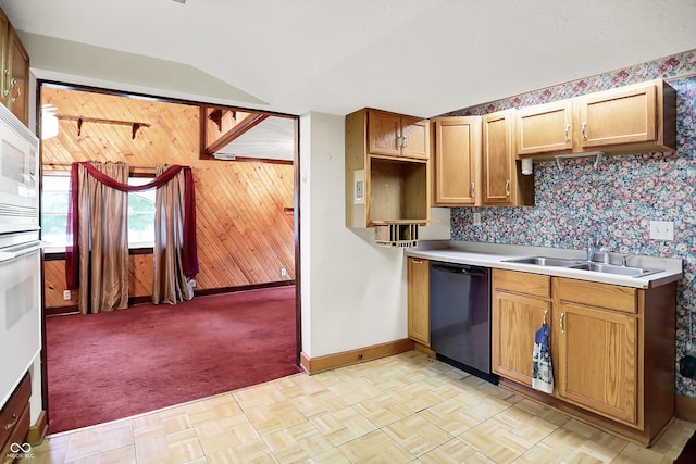 6430 E Southport Rd, Indianapolis, IN 46237 - kitchen with dishwashing machine, wood walls, vaulted ceiling, light countertops, and light carpet