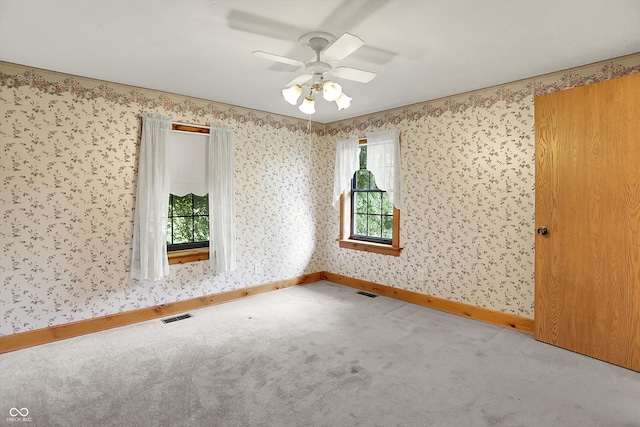 6430 E Southport Rd, Indianapolis, IN 46237 - spare room featuring carpet flooring, a ceiling fan, and wallpapered walls