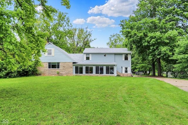6430 E Southport Rd, Indianapolis, IN 46237 - rear view of property with a lawn and stone siding