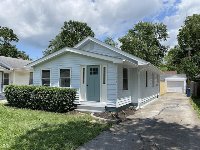 5115 Primrose Ave, Indianapolis, IN 46205 - view of front of home featuring an outbuilding, concrete driveway, a detached garage, and a front yard