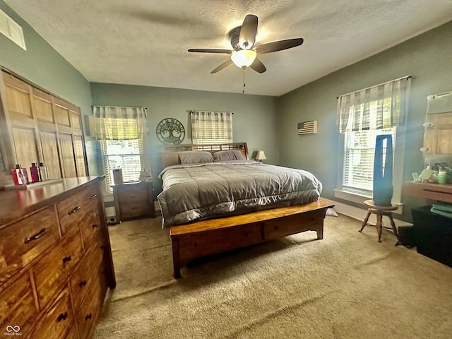 208 10th St, Covington, IN 47932 - bedroom featuring light carpet, a textured ceiling, multiple windows, and a ceiling fan