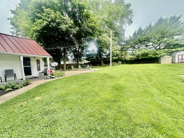 208 10th St, Covington, IN 47932 - view of grassy yard featuring a shed and a patio