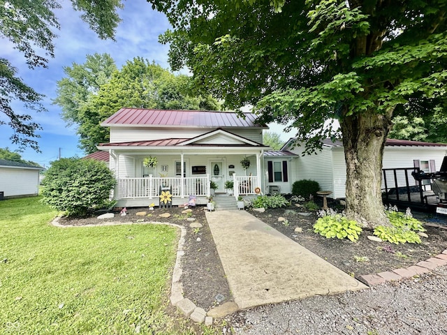 208 10th St, Covington, IN 47932 - view of front facade with a porch, a front yard, and a metal roof