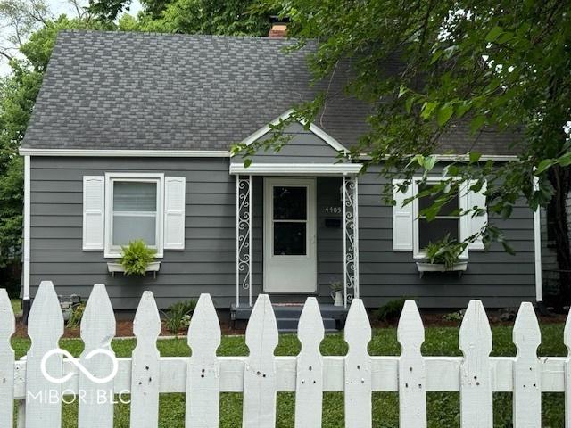 4405 Primrose Ave, Indianapolis, IN 46205 - view of front of home featuring roof with shingles and a chimney