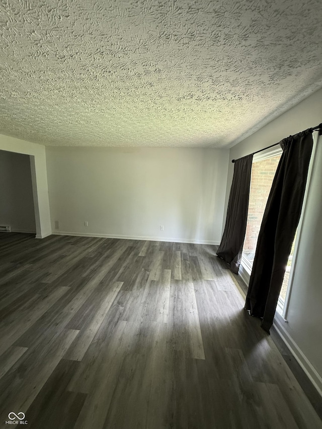 8434 Meadowlark Dr, Indianapolis, IN 46226 - empty room featuring dark wood-type flooring and a textured ceiling